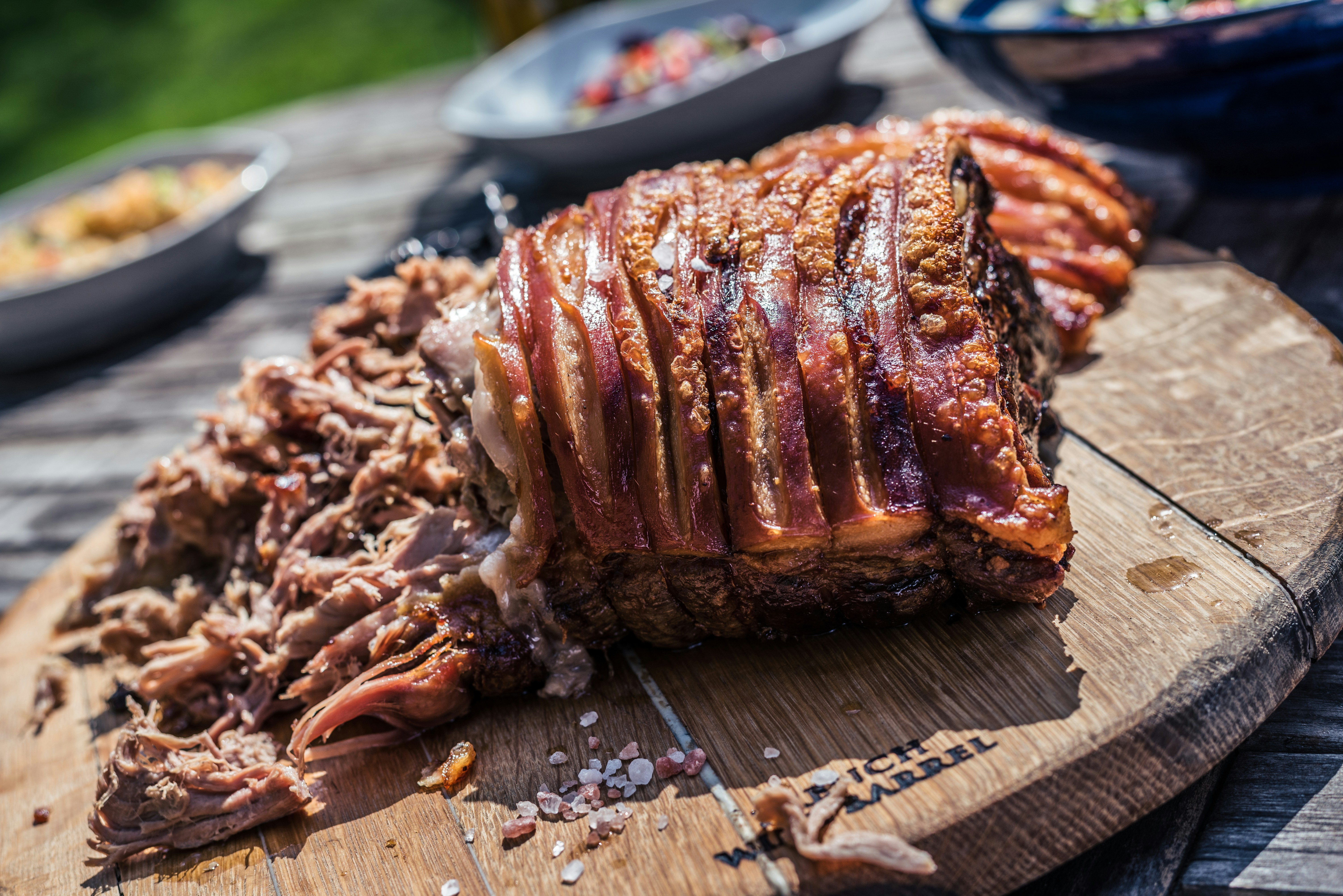 Crispy smoked pork shoulder on a wooden board