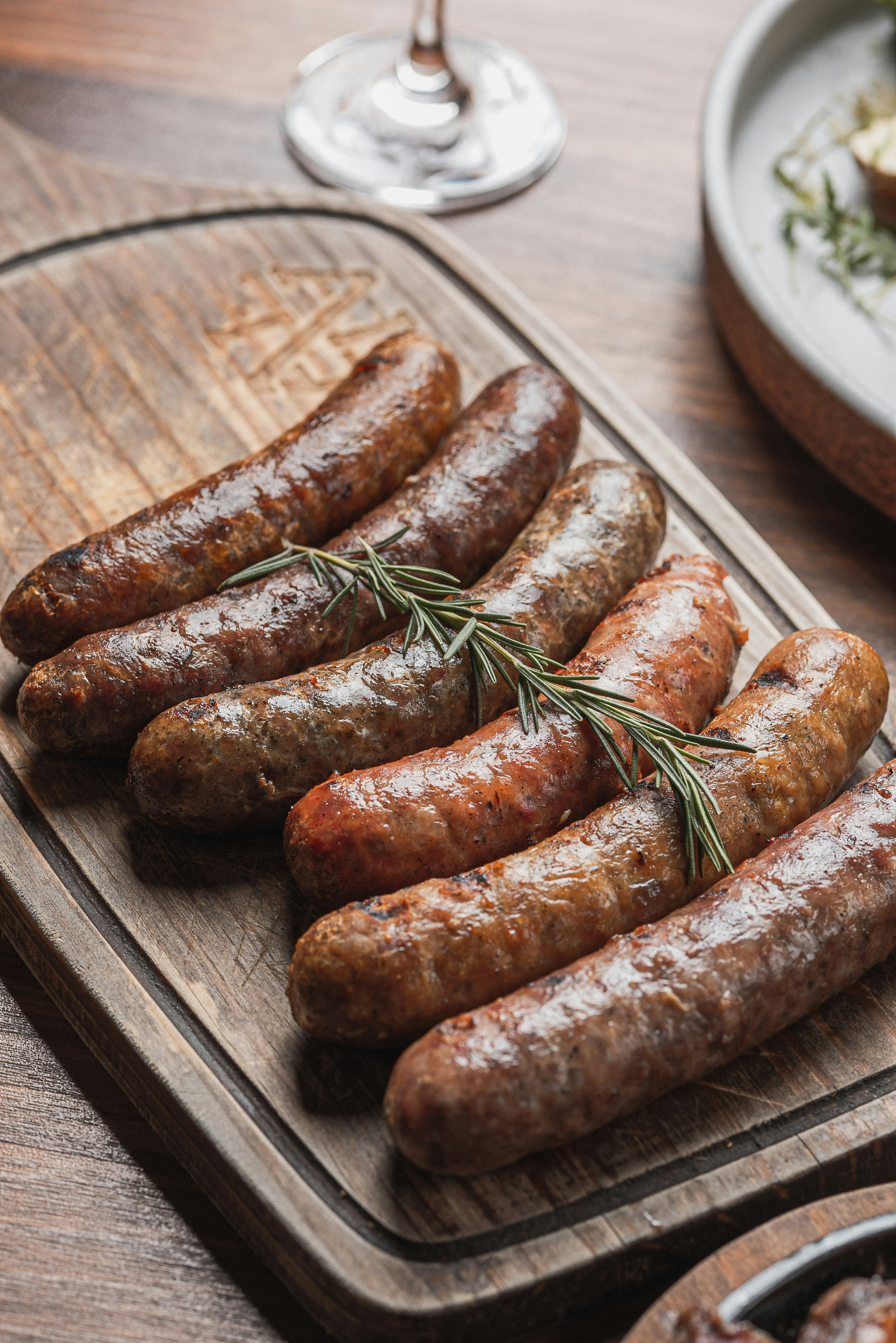 Grilled sausage links on a wooden board
