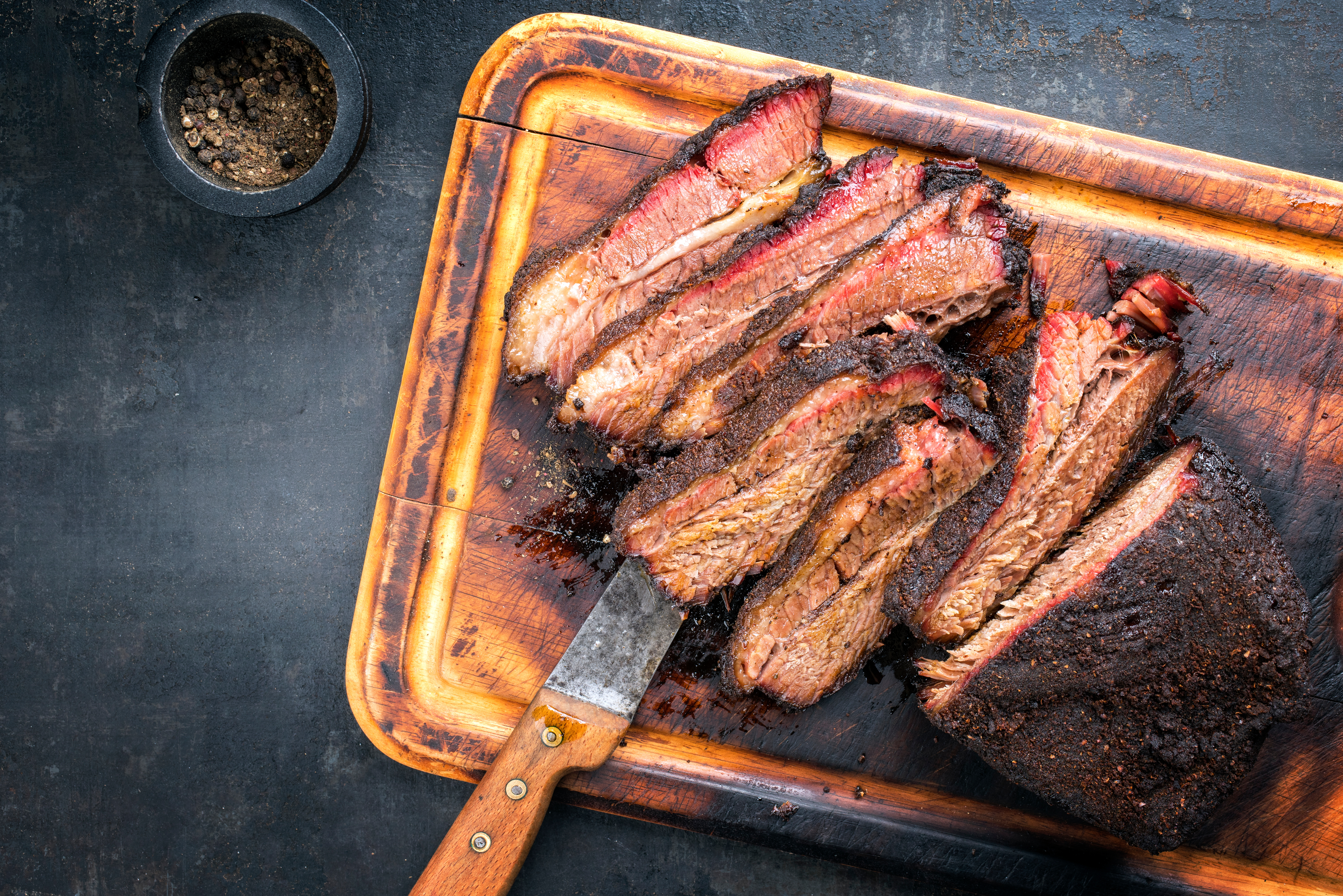 Sliced smoked brisket with a deep smoke ring