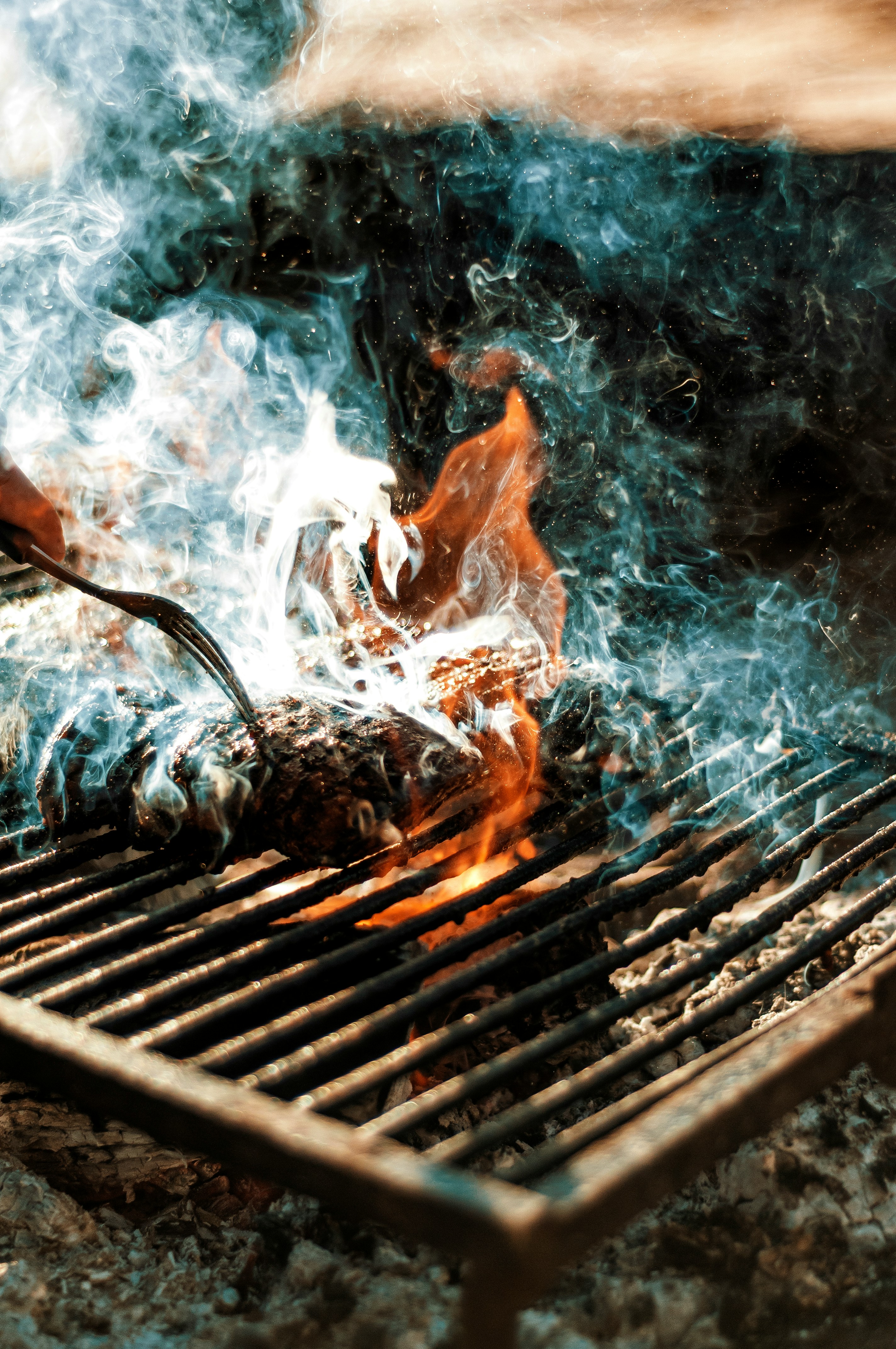 Smoke and flames rising from a barbecue grill